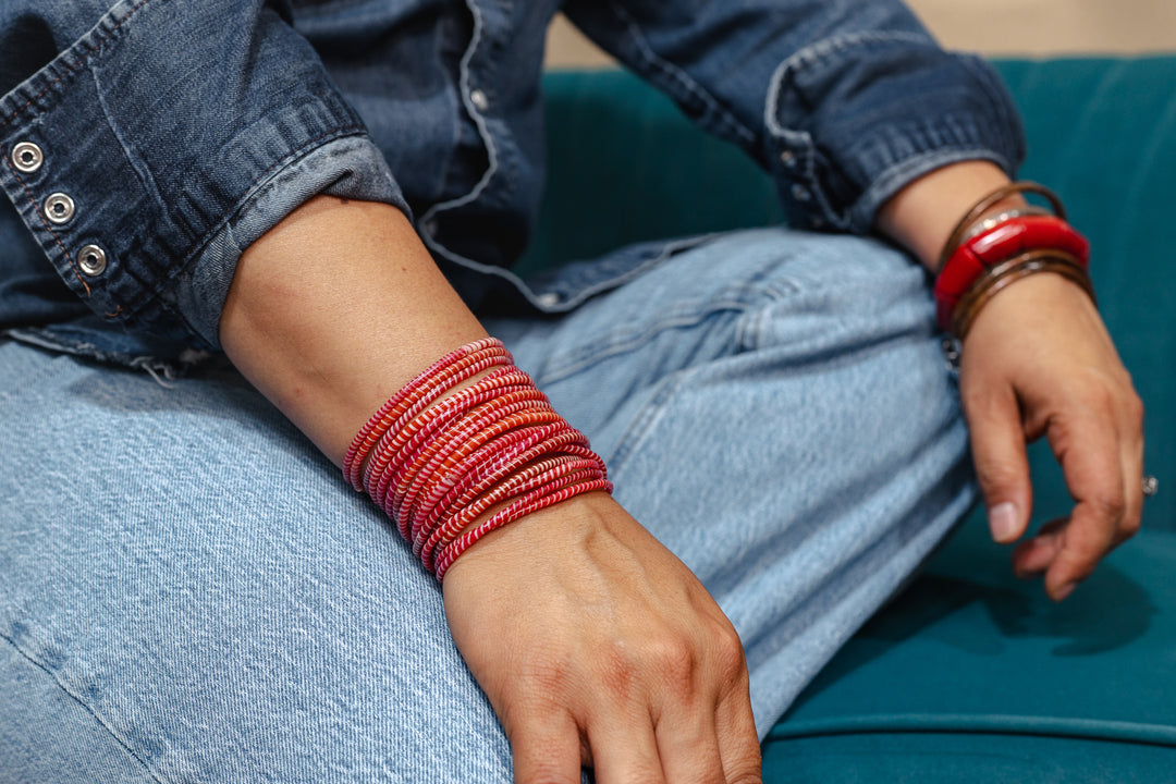Red and white recycled flip flop bracelets handmade in Mali, West Africa featuring lightweight waterproof bangles perfect for boho arm stacks, beach jewelry, festival fashion, layered bracelets, artisan gifts, and colorful summer accessories.