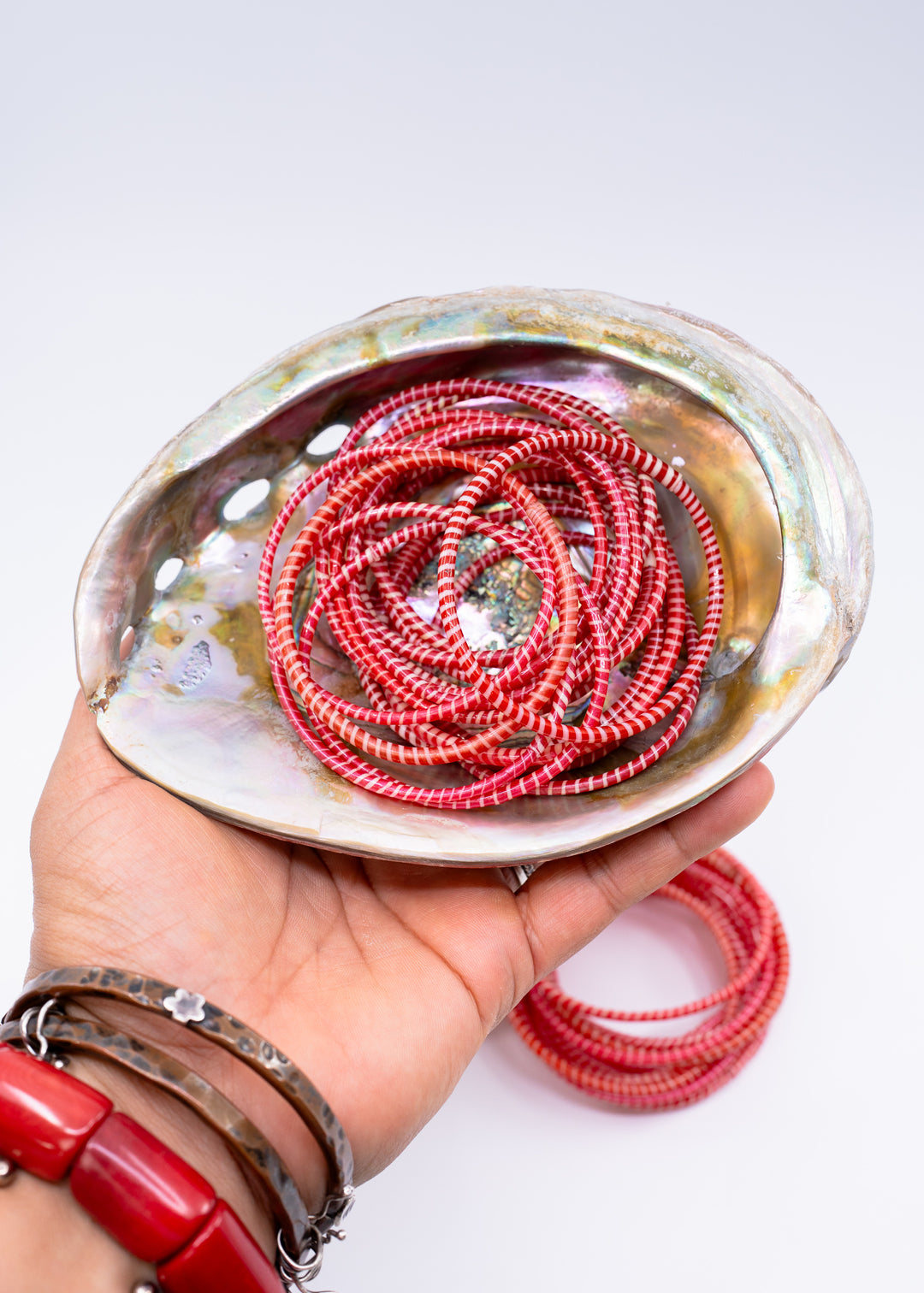 Red and white recycled flip flop bracelets handmade in Mali, West Africa featuring lightweight waterproof bangles perfect for boho arm stacks, beach jewelry, festival fashion, layered bracelets, artisan gifts, and colorful summer accessories.