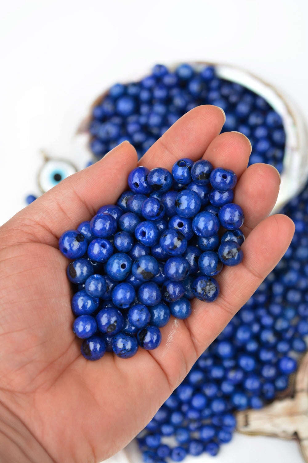 Royal Blue Acai Beads details in the hands.