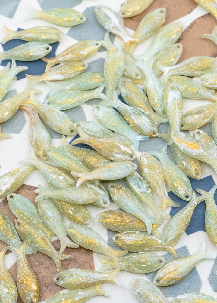 Seafoam Pearl Shimmer charms handmade from glitter German resin featuring a light green with golden glittery sardine pendants perfect for ocean jewelry, mermaidcore accessories, beach fashion, coastal earrings, whimsical summer jewelry, and festival-inspired designs. These fish ocean charms are waterproof and perfect for beach jewelry.