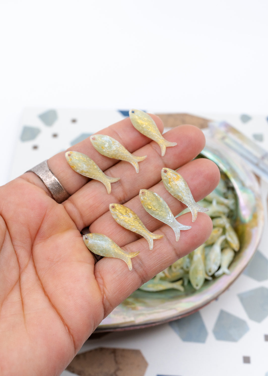 Seafoam Pearl Shimmer charms handmade from glitter German resin featuring a light green with golden glittery sardine pendants perfect for ocean jewelry, mermaidcore accessories, beach fashion, coastal earrings, whimsical summer jewelry, and festival-inspired designs. These fish ocean charms are waterproof and perfect for beach jewelry.