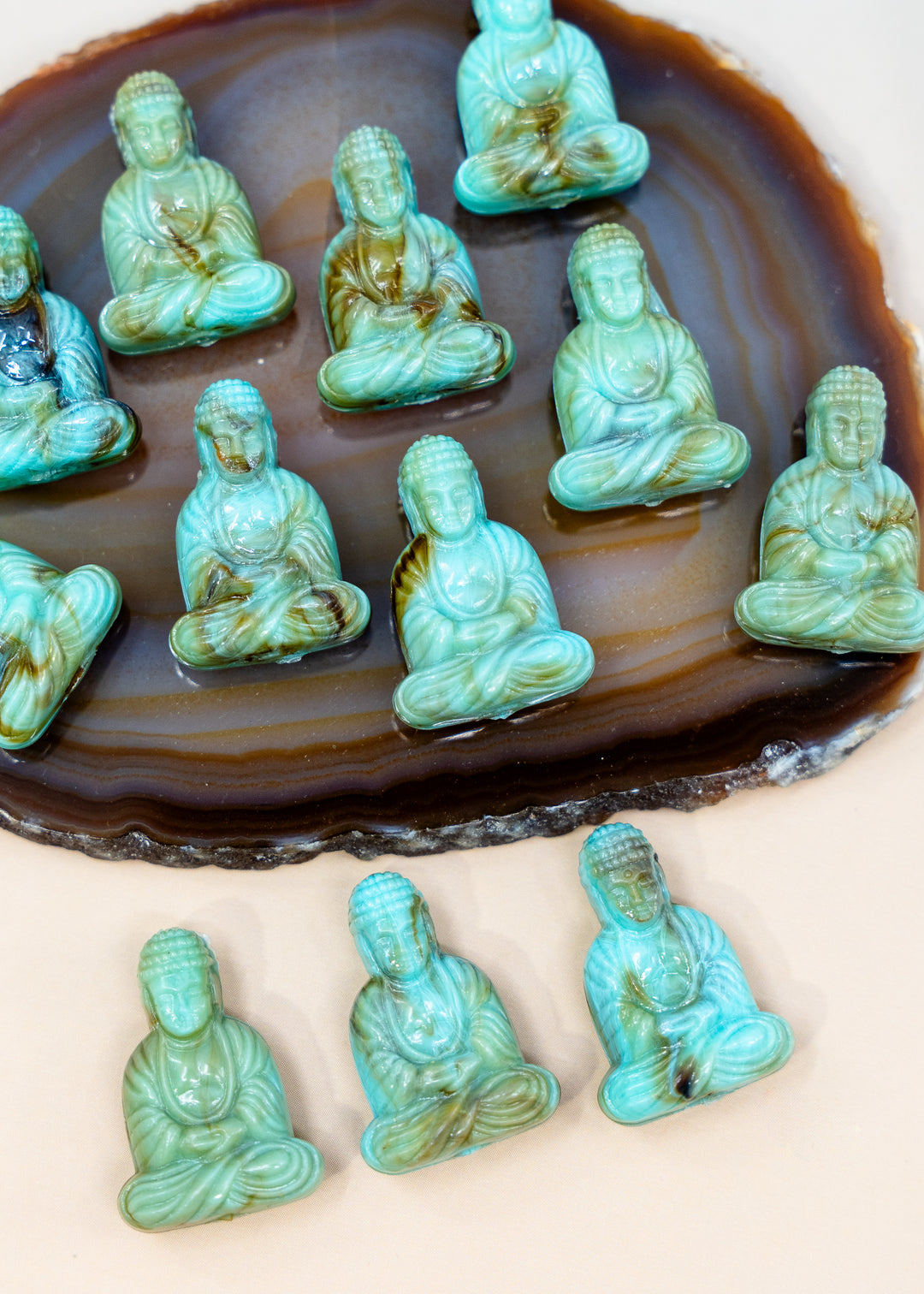 Shop a Lagoon Driftwood Buddha pendant in 25mm marbled resin. Lightweight sitting Buddha charm for necklaces, malas, meditation and spiritual jewelry.