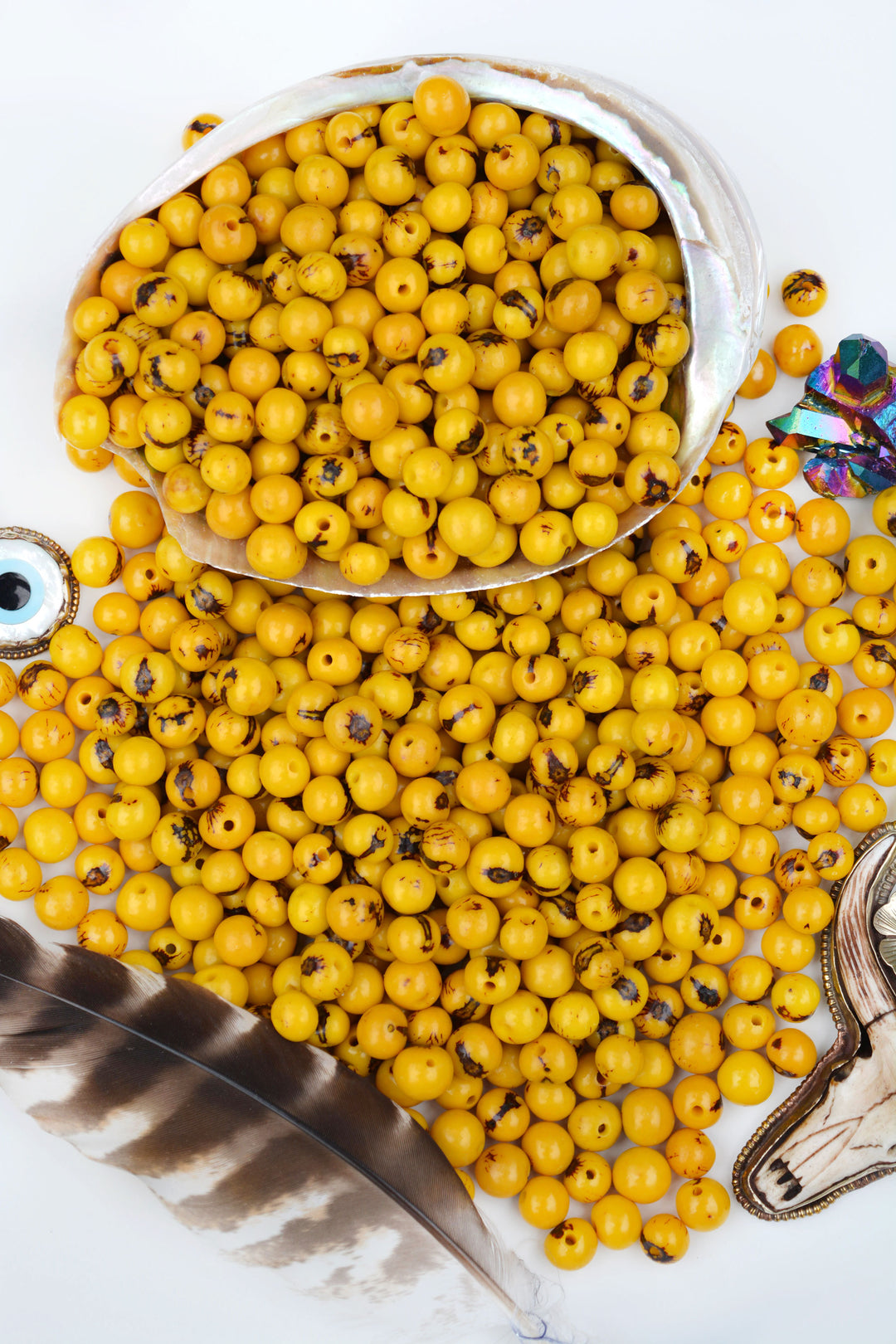 A beautiful display of all sizes of natural acai beads in yellow.
