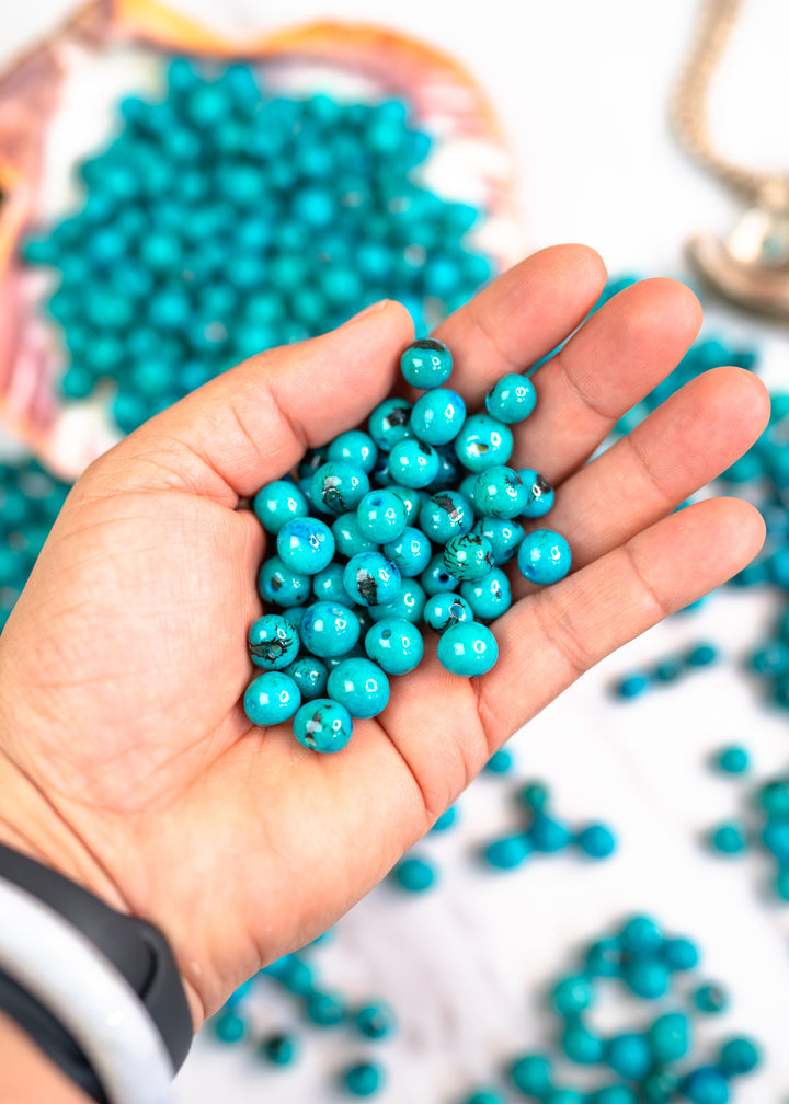 Close-up detail of Turquoise Blue Acai Beads in a Jewelry maker&