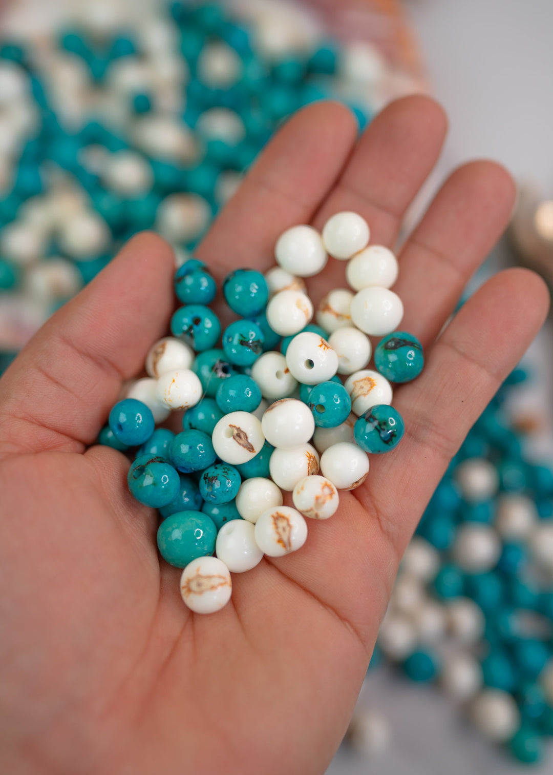 A close up of the Aai Beads in the hands
