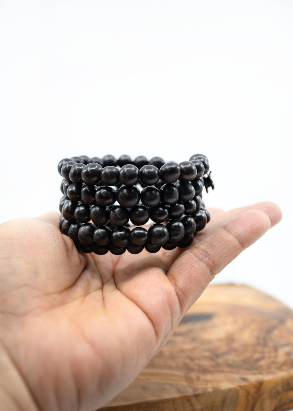 Acai beads Memory Wire Bracelet displayed on a hand to show the size.