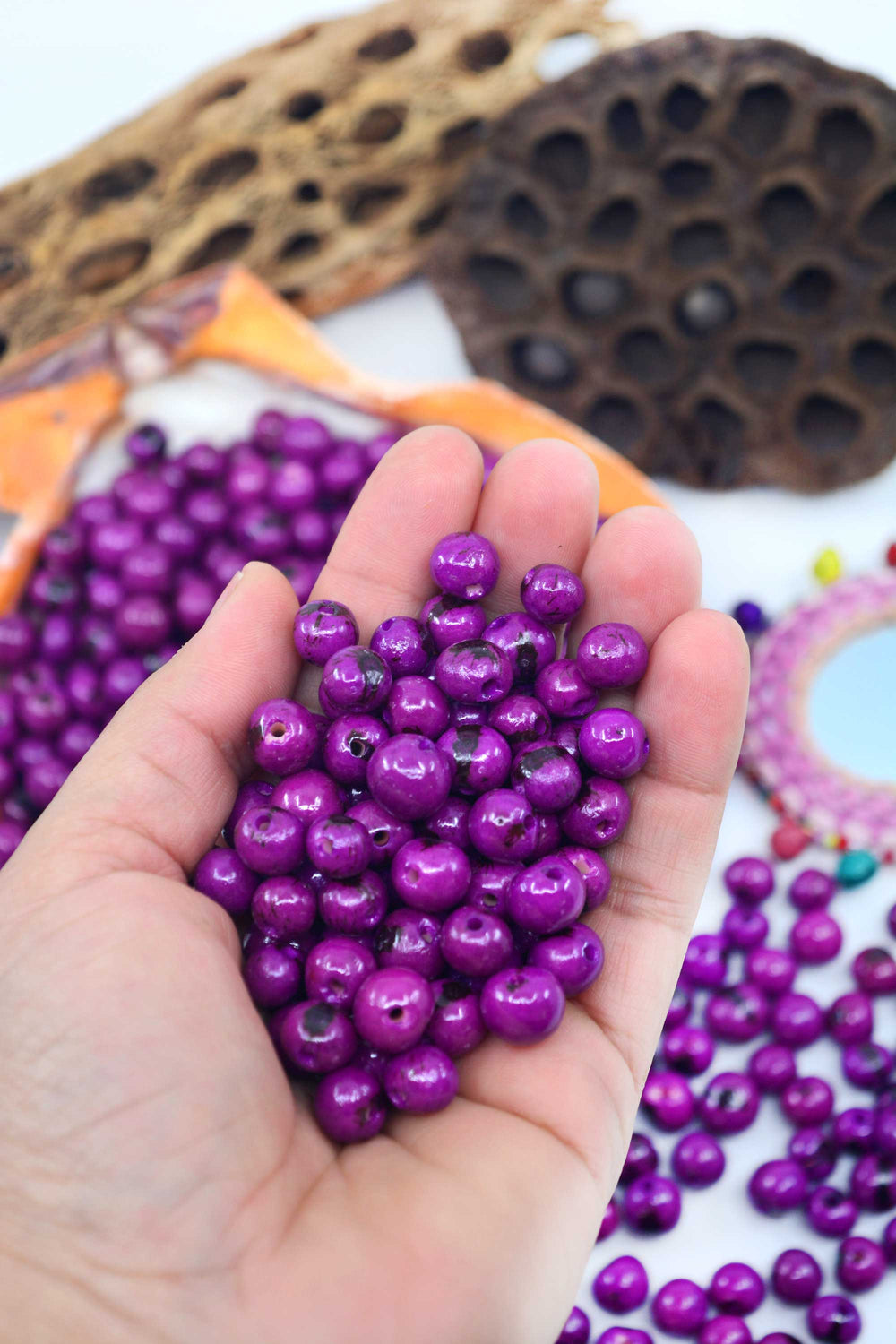 close-up of purple acai beads in the hands.
