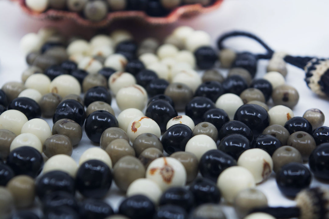 Black Pearl, Black, White and Gray Acai Beads showing the size of the holes.
