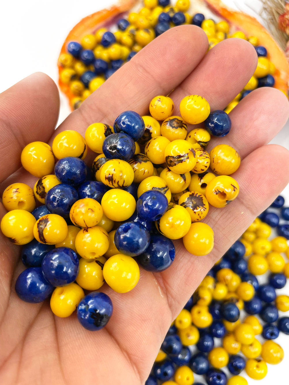 Close-up of Acai Beads in the hands.