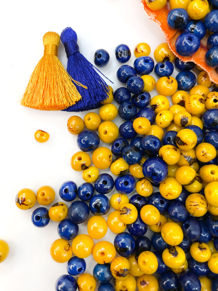 Close-up of acai beads showing the variance of acai beads in size and natural markings.
