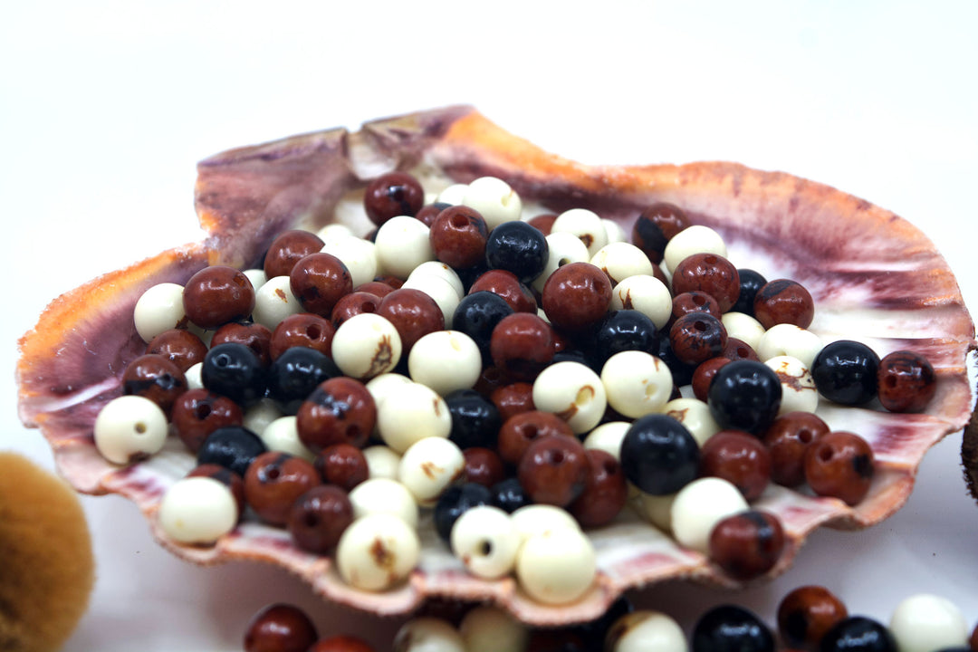 Cookies and Cream, Brown, White and Black Acai Beads showing the natural markings and bead holes.