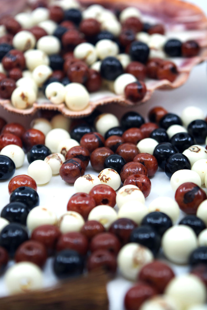 Cookies and Cream, Brown, White and Black Acai Beads showing the variance in size.