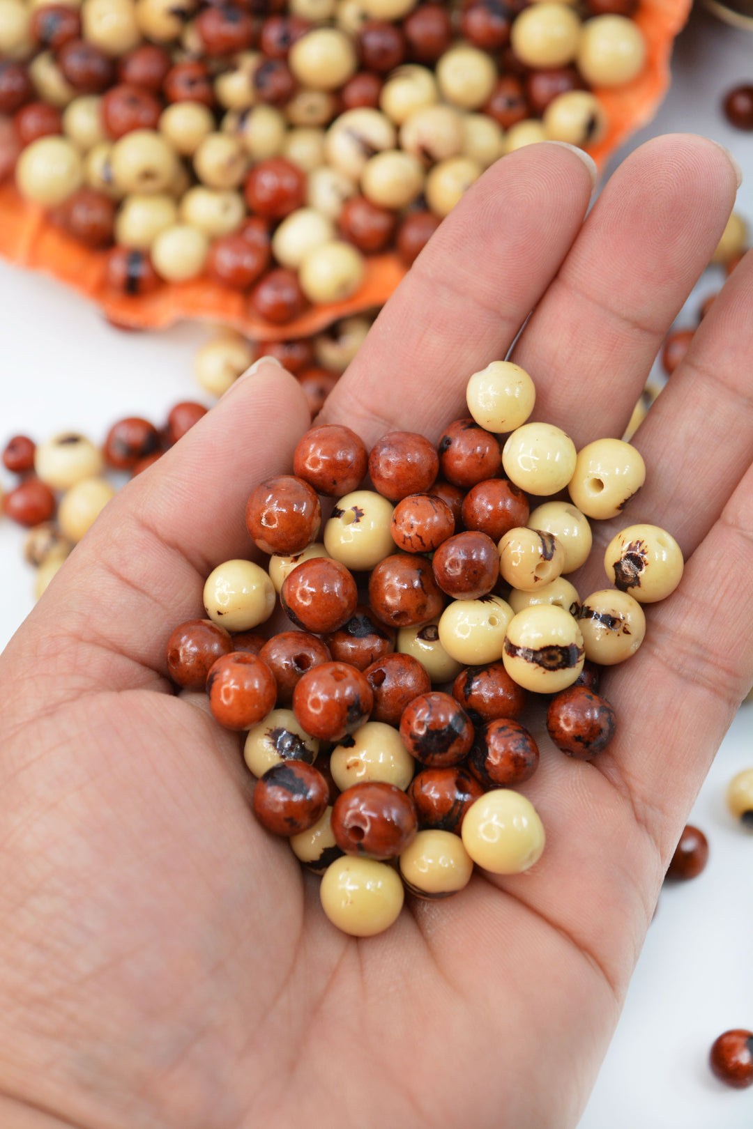 Brown and Cream Acai Beads details in the hands.