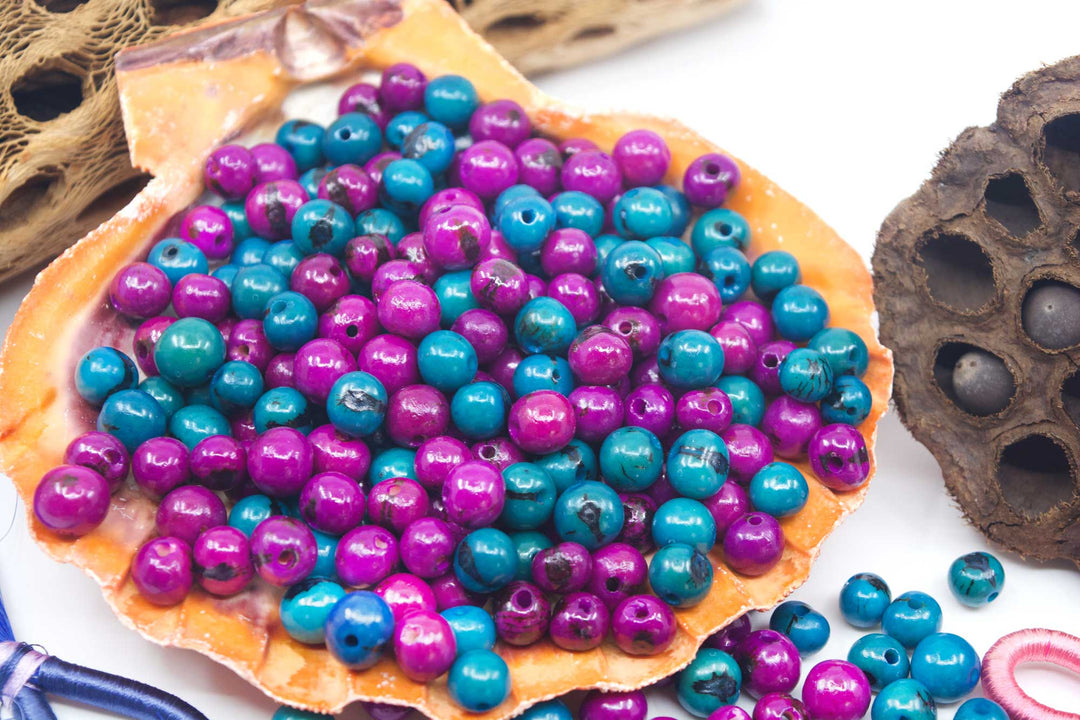 A display of natural acai beads in a seashell.
