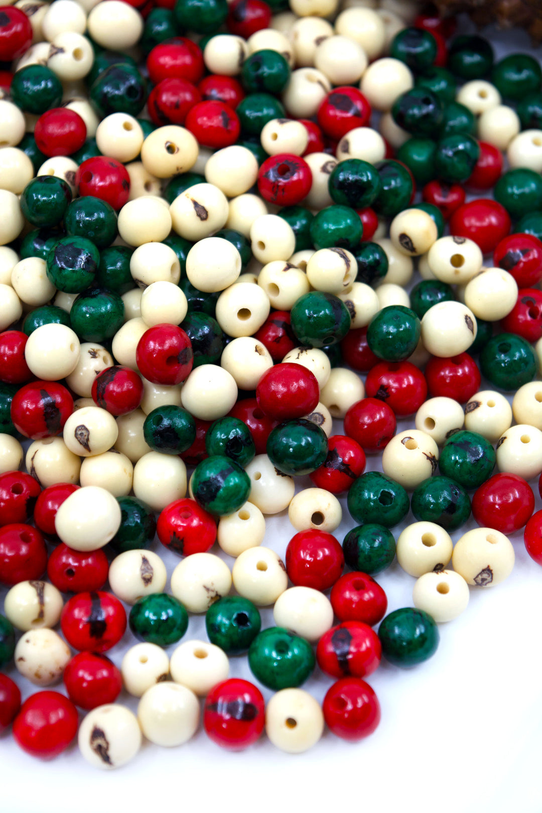 Natural Acai Beads mix in red, green, white and ready for jewelry making.