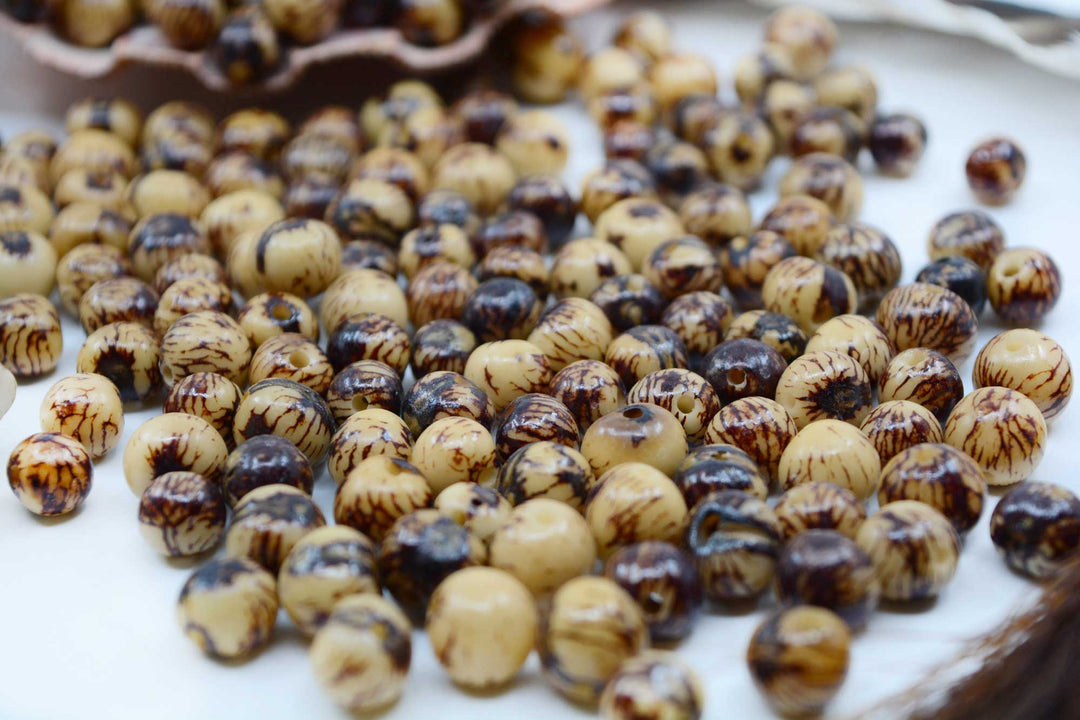 Natural Brown and Cream Real Acai Beads close-up showing the natural colors of the polished acai beads.