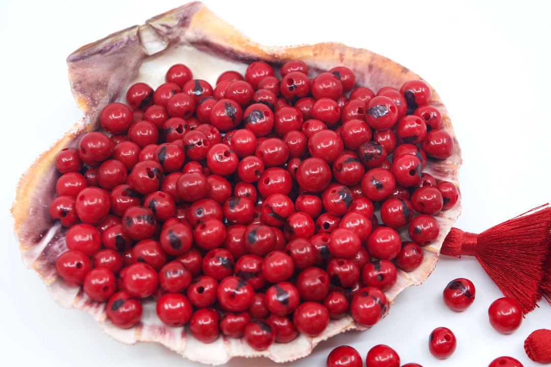 Scarlet Red Acai Beads close-up in a seashell, natural beads.