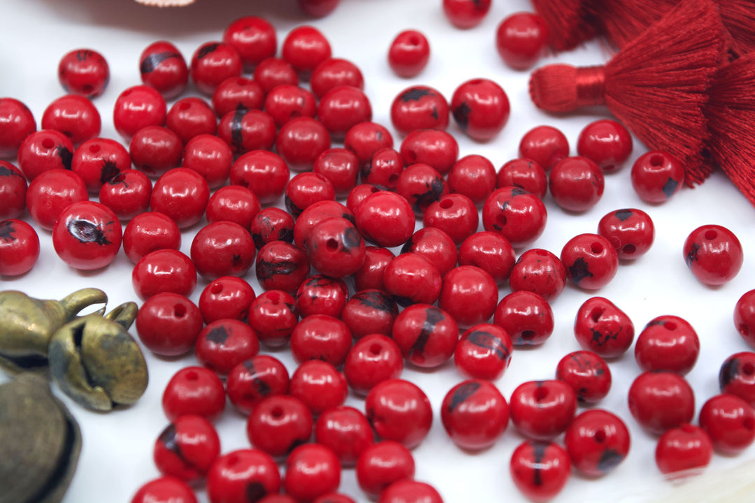 Scarlet Red Acai Beads showing variance of the beads.