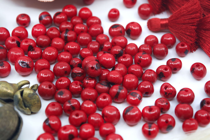 Scarlet Red Acai Beads showing variance of the beads.