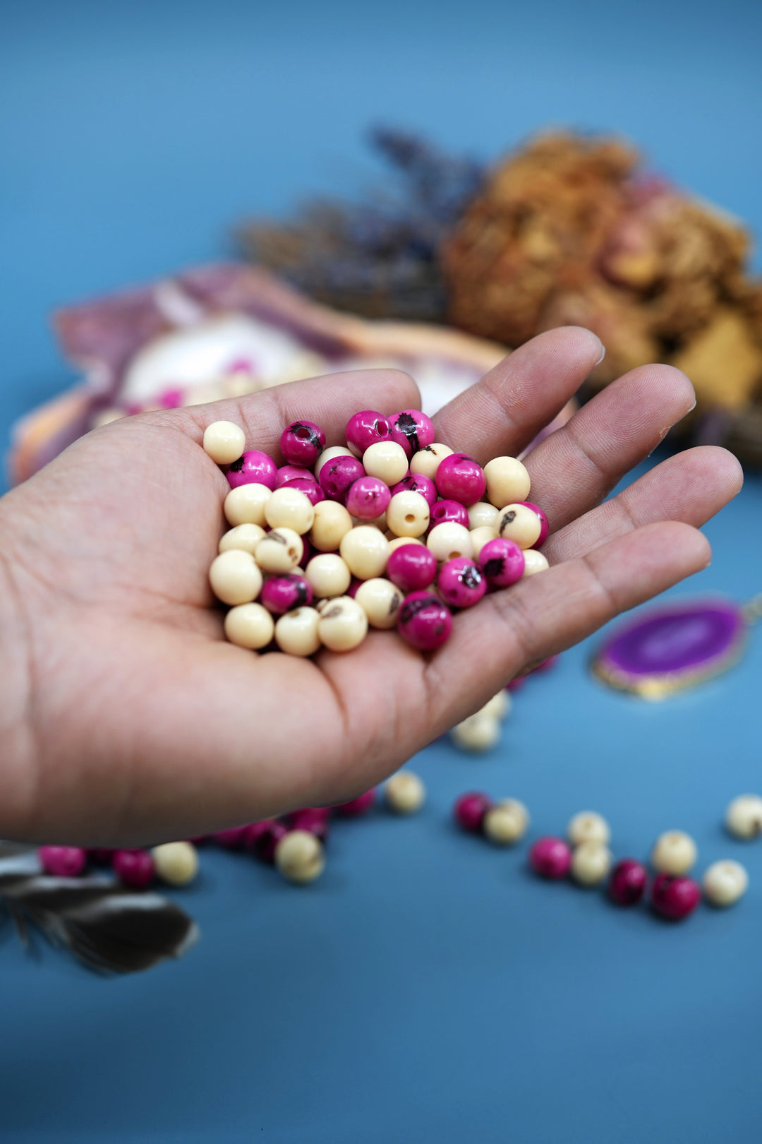 Various sizes of two shades of Acai beads for jewelry making.